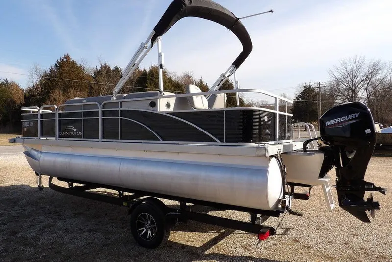 Slide: The Image of 2020 Bennington 20 SFV pontoon boat with Mercury outboard motor on a trailer. - 3