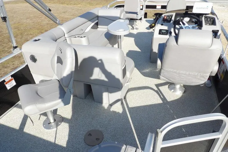 Slide: The Image of 2020 Bennington 20 SFV pontoon boat interior with gray seating and steering console. - 30