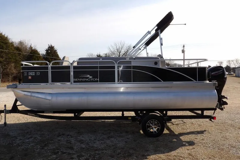 Slide: The Image of 2020 Bennington 20 SFV pontoon boat on trailer, side view, outdoors. - 4