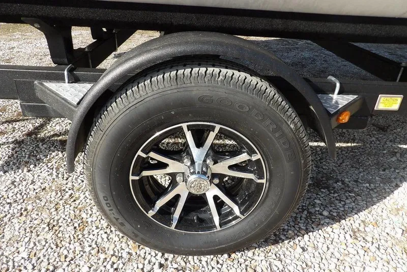 Slide: The Image of 2020 Bennington 20 SFV trailer wheel with Goodride tire on gravel surface. - 41