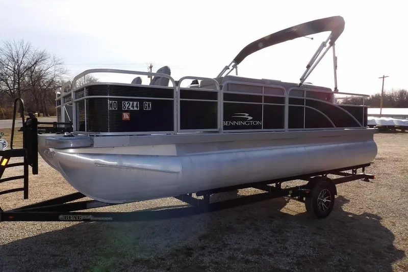 Slide: The Image of 2020 Bennington 20 SFV pontoon boat on trailer, parked outdoors. - 5