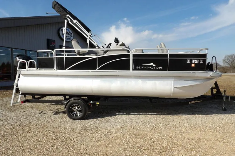 Slide: The Image of 2020 Bennington 20 SFV pontoon boat on trailer, parked outdoors. - 6