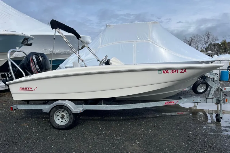 Slide: The Image of 2018 Boston Whaler 170 Super Sport boat on trailer, parked outdoors. - 0