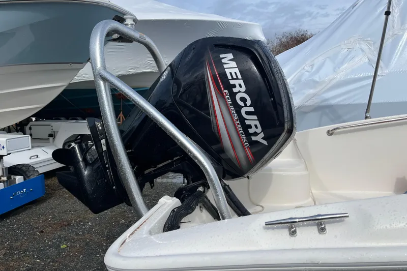 Slide: The Image of 2018 Boston Whaler 170 Super Sport with Mercury FourStroke engine, docked outdoors. - 1
