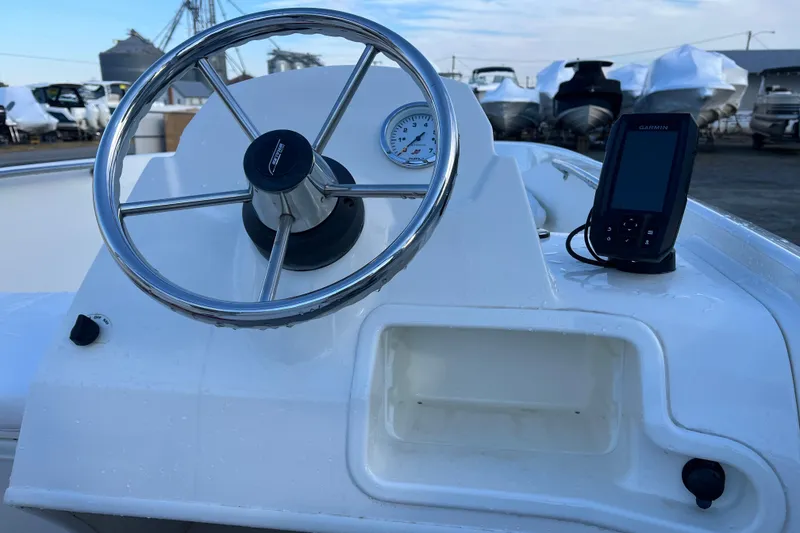 Slide: The Image of 2018 Boston Whaler 170 Super Sport dashboard with steering wheel and Garmin device. - 10