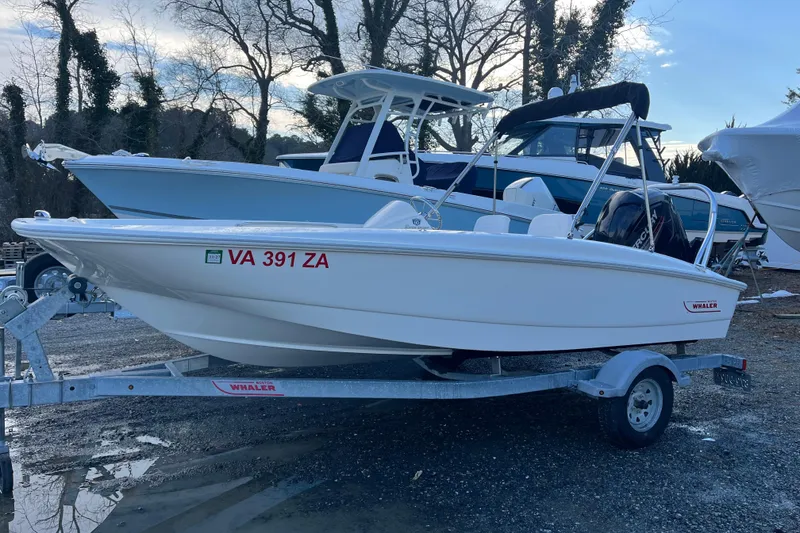 Slide: The Image of 2018 Boston Whaler 170 Super Sport boat on trailer, parked outdoors. - 15