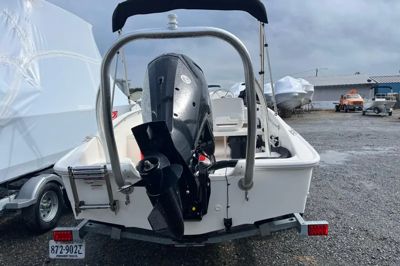 Slide: The Image of 2018 Boston Whaler 170 Super Sport boat on trailer, rear view with outboard motor. - 19