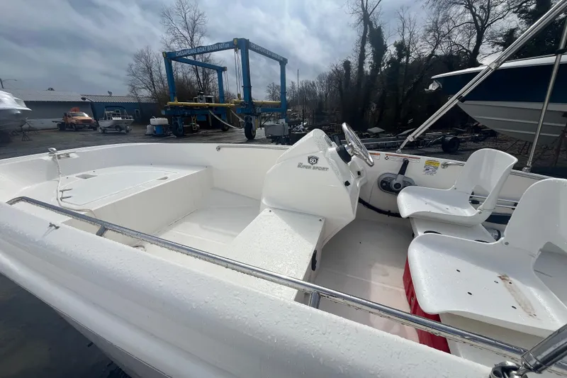 Slide: The Image of 2018 Boston Whaler 170 Super Sport boat interior at a marina. - 3