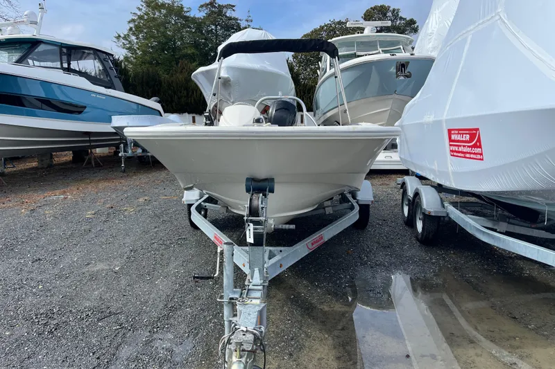 Slide: The Image of 2018 Boston Whaler 170 Super Sport boat on trailer, parked outdoors. - 5