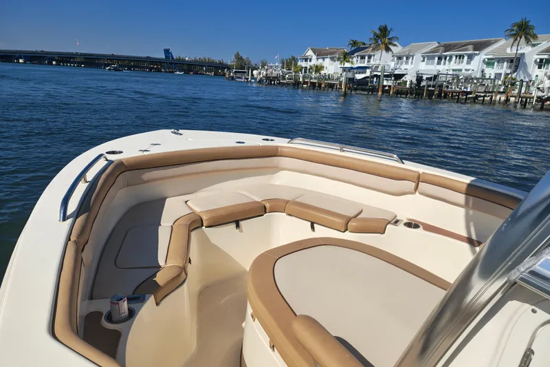Slide: The Image of 2020 Scout 215 XSF boat interior with waterfront view and residential backdrop. - 1