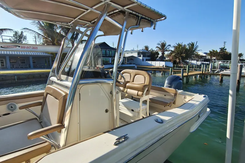 Slide: The Image of 2020 Scout 215 XSF boat docked in sunny marina with palm trees. - 16