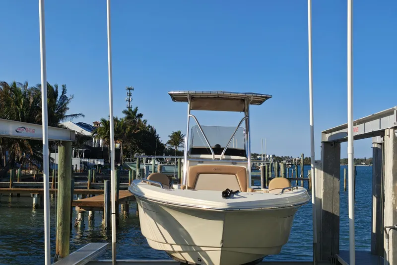 Slide: The Image of 2020 Scout 215 XSF boat docked at a marina with clear blue skies. - 18