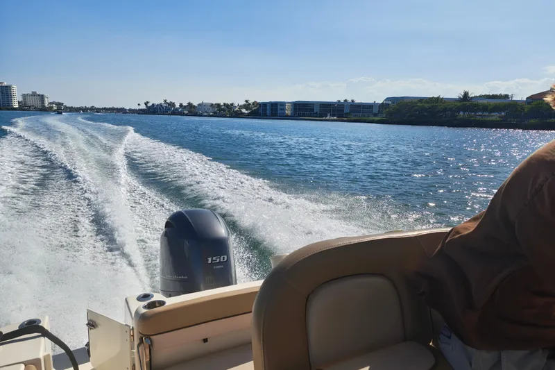 Slide: The Image of 2020 Scout 215 XSF boat cruising on a sunny day, leaving a wake behind. - 9