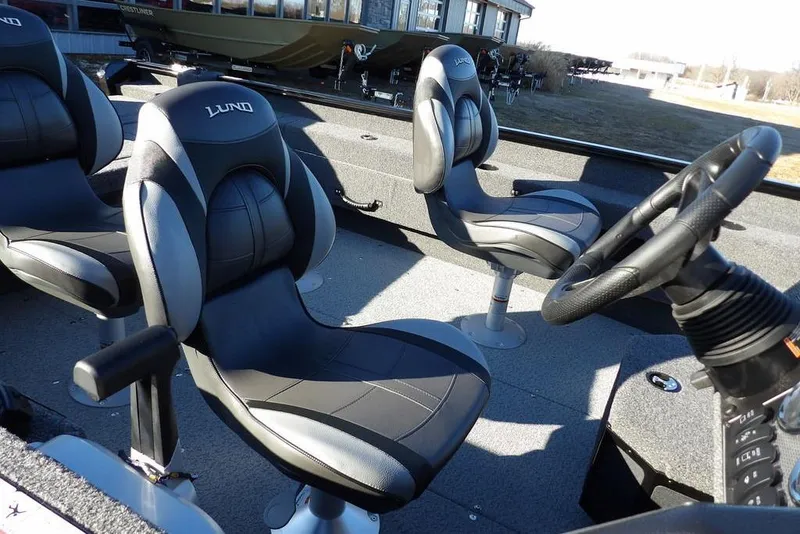 Slide: The Image of 2025 Lund 1775 Adventure SS boat interior with comfortable seating and steering wheel. - 11