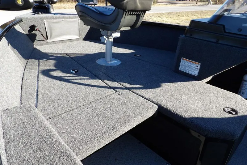 Slide: The Image of 2025 Lund 1775 Adventure SS boat interior with seating and carpeted deck. - 12