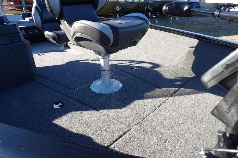 Slide: The Image of 2025 Lund 1775 Adventure SS boat interior with swivel seat and carpeted deck. - 13