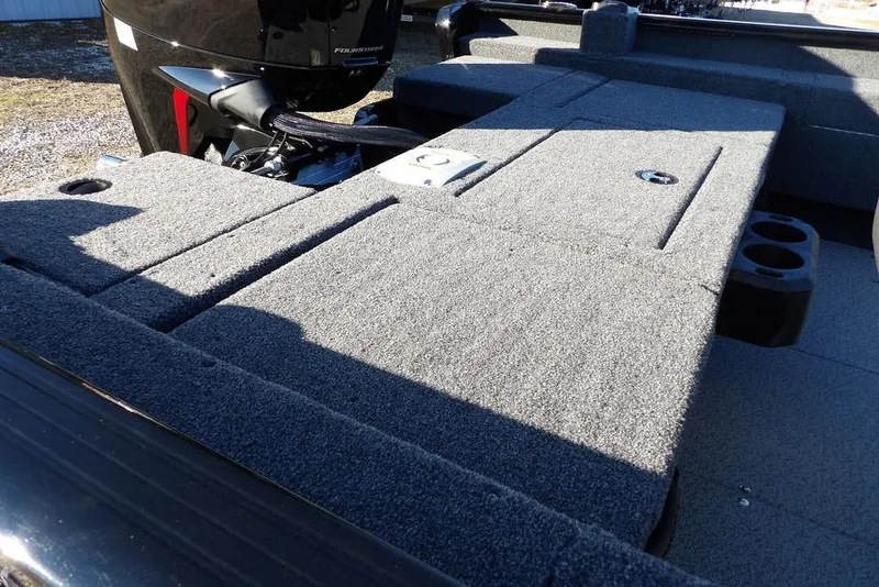 Slide: The Image of 2025 Lund 1775 Adventure SS boat deck with carpeted surface and motor. - 14