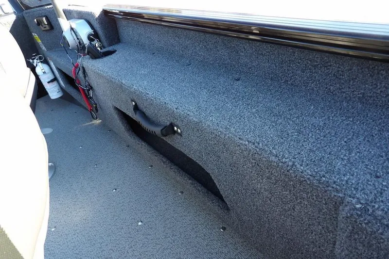 Slide: The Image of 2025 Lund 1775 Adventure SS interior with carpeted storage and safety equipment. - 20