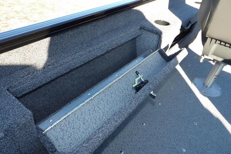 Slide: The Image of 2025 Lund 1775 Adventure SS boat interior with storage compartment and seating. - 22