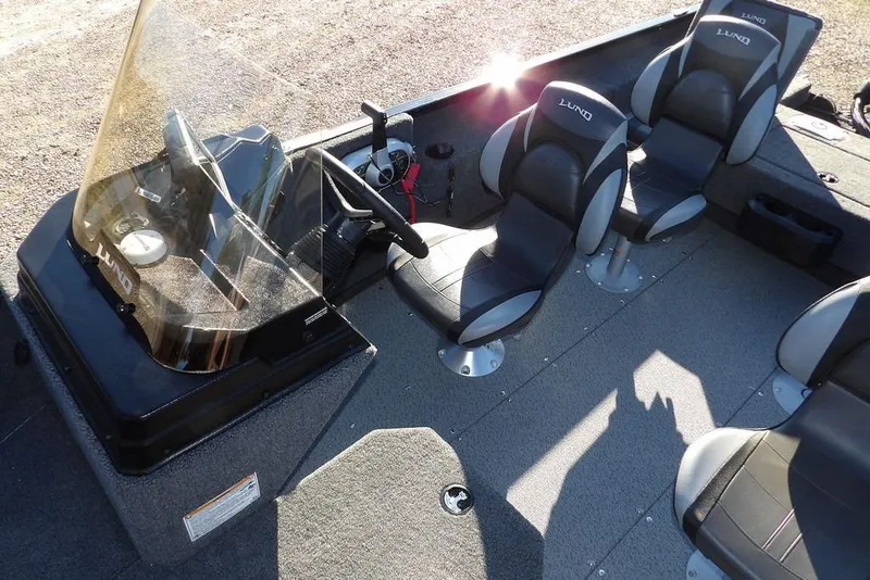 Slide: The Image of 2025 Lund 1775 Adventure SS boat interior with seating and steering console. - 24