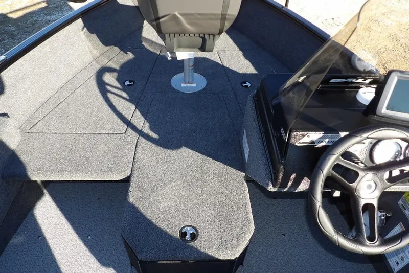 Slide: The Image of 2025 Lund 1775 Adventure SS boat interior with steering wheel and seating area. - 28