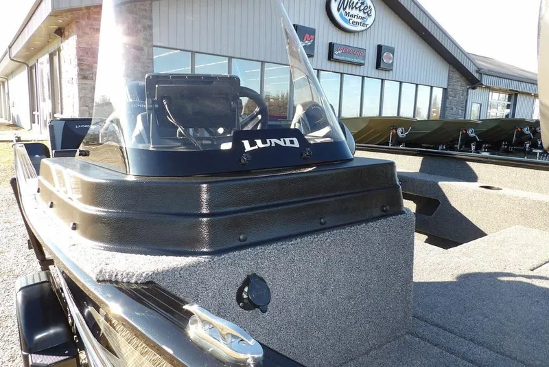 Slide: The Image of 2025 Lund 1775 Adventure SS boat at marine center, showcasing console and windshield. - 37