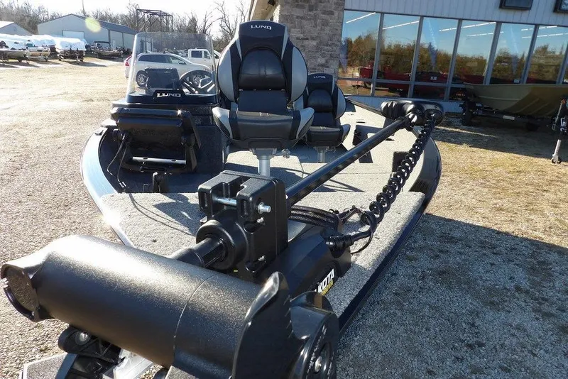 Slide: The Image of 2025 Lund 1775 Adventure SS boat with trolling motor and seating, parked outdoors. - 6