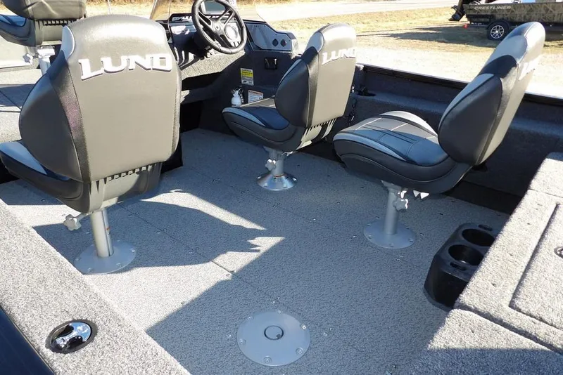 Slide: The Image of 2025 Lund 1775 Adventure SS boat interior with three swivel seats and carpeted flooring. - 8