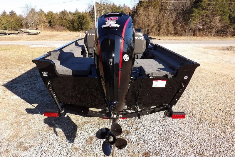 Slide: The Image of 2025 Lund 1775 Adventure SS boat with Mercury outboard motor, parked on gravel. - 9