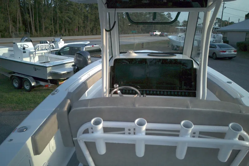 Slide: The Image of 2024 Sea Hunt Gamefish 30 Coffin Box boat interior with steering console and rod holders. - 11