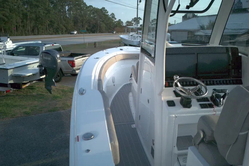 Slide: The Image of 2024 Sea Hunt Gamefish 30 Coffin Box boat interior with steering console and seating. - 12