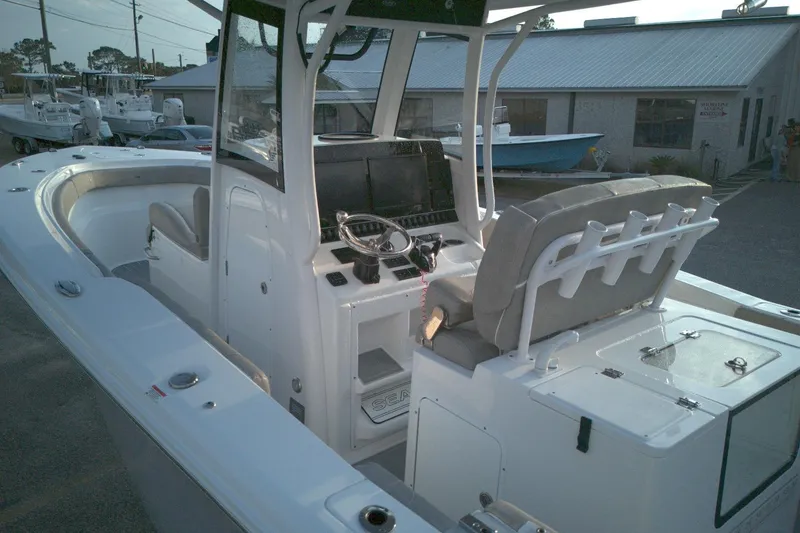 Slide: The Image of 2024 Sea Hunt Gamefish 30 Coffin Box boat interior with helm and seating. - 13