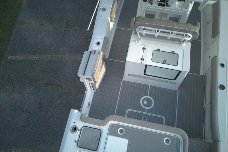 Slide: The Image of 2024 Sea Hunt Gamefish 30 Coffin Box boat interior with seating and storage compartments. - 15