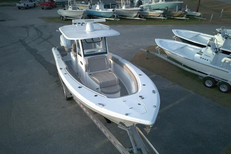 Slide: The Image of 2024 Sea Hunt Gamefish 30 Coffin Box boat on trailer in marina setting. - 3