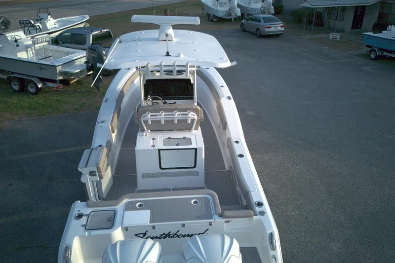 Slide: The Image of 2024 Sea Hunt Gamefish 30 Coffin Box boat, aerial view, parked in a lot. - 6