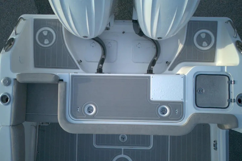 Slide: The Image of 2024 Sea Hunt Gamefish 30 Coffin Box boat deck with dual engines and storage compartments. - 9