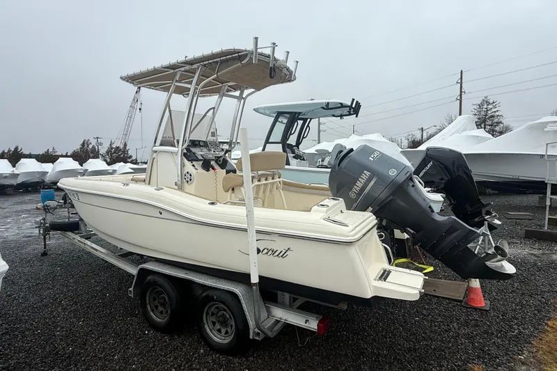 Slide: The Image of 2014 Scout 210 XSF boat on trailer with Yamaha outboard motor in storage yard. - 1
