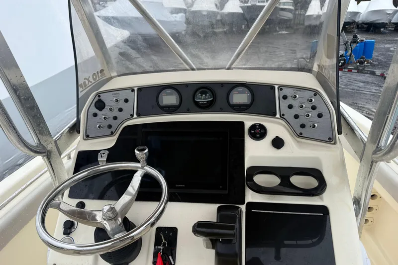 Slide: The Image of 2014 Scout 210 XSF boat dashboard with steering wheel and control panel. - 4