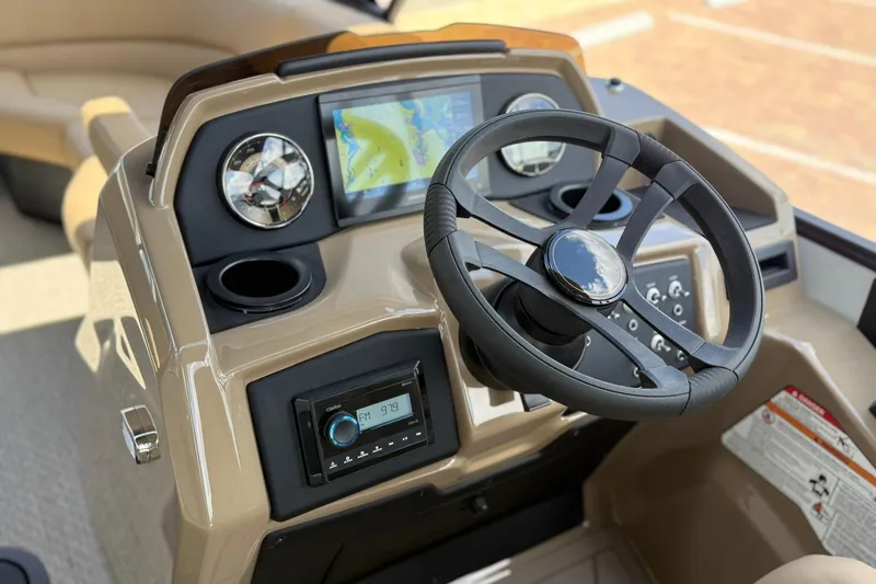 Slide: The Image of 2026 Evotti 523QL boat dashboard with steering wheel, GPS, and radio controls. - 11