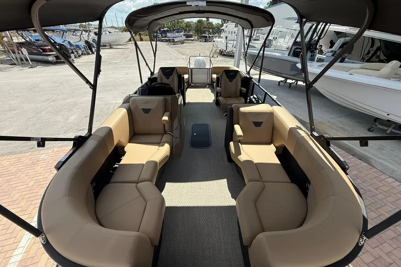 Slide: The Image of Luxurious 2026 Evotti 523QL boat interior with tan seating and canopy, docked at marina. - 4