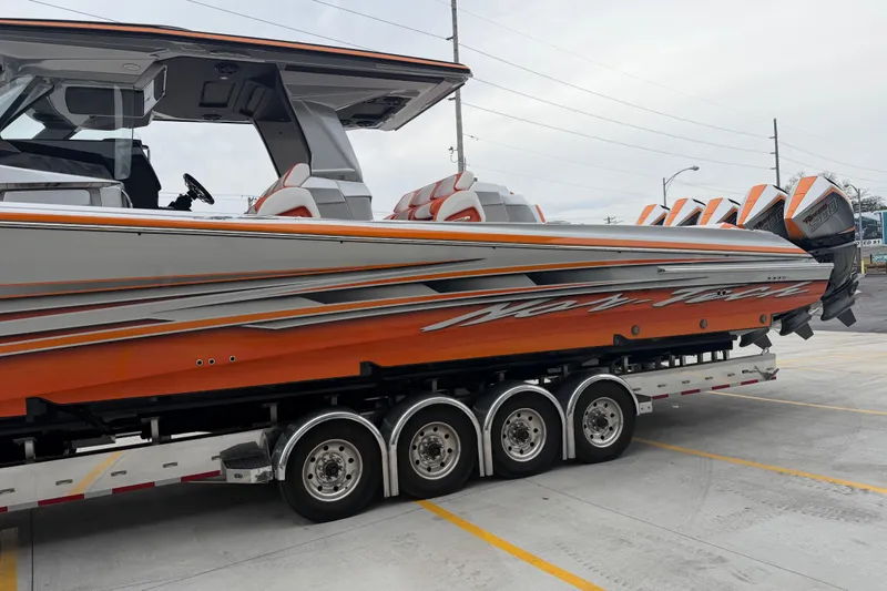 Slide: The Image of 2024 Nor-Tech 500 Sport Center Console boat on trailer, featuring vibrant orange and gray design. - 10