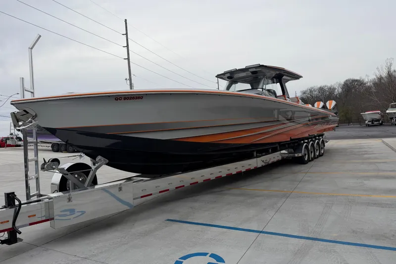 Slide: The Image of 2024 Nor-Tech 500 Sport Center Console boat on trailer, parked outdoors. - 12