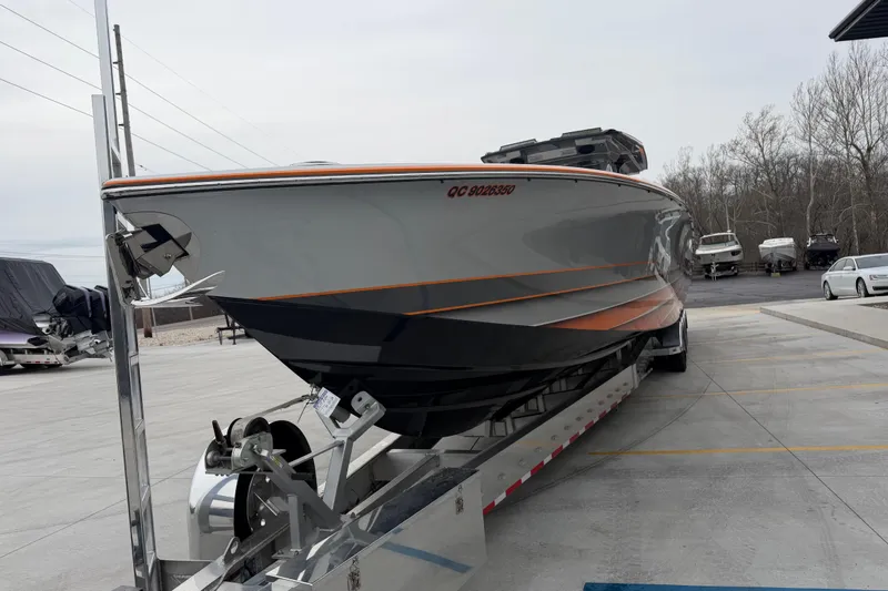 Slide: The Image of 2024 Nor-Tech 500 Sport Center Console boat on trailer in parking lot. - 13