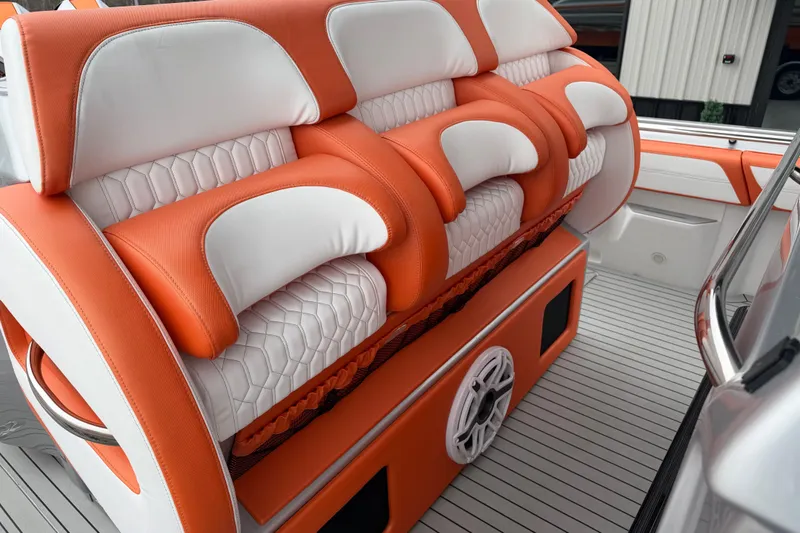 Slide: The Image of 2024 Nor-Tech 500 Sport Center Console with orange and white seating, showcasing luxury design. - 20