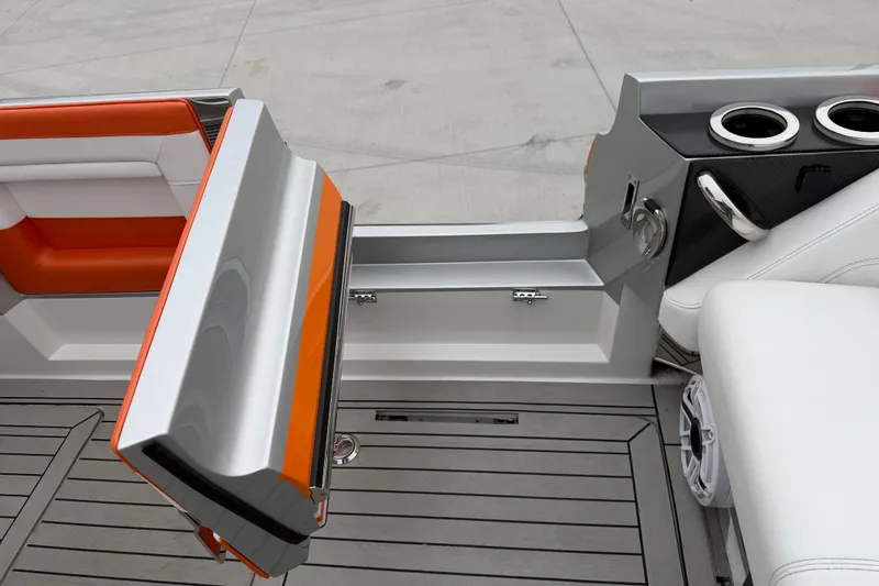 Slide: The Image of 2024 Nor-Tech 500 Sport Center Console interior with orange accents and cup holders. - 21