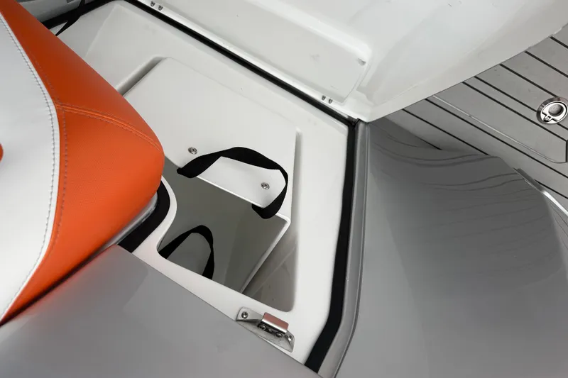 Slide: The Image of 2024 Nor-Tech 500 Sport Center Console storage compartment with orange and white seating. - 22