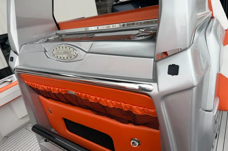 Slide: The Image of 2024 Nor-Tech 500 Sport Center Console, sleek silver and orange design, luxury boat interior. - 23