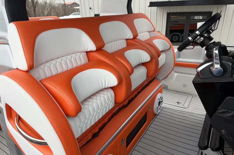 Slide: The Image of 2024 Nor-Tech 500 Sport Center Console interior with orange and white seating. - 25