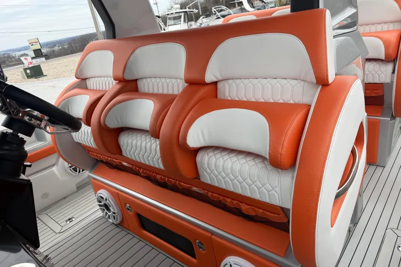 Slide: The Image of 2024 Nor-Tech 500 Sport Center Console interior with orange and white seating. - 26
