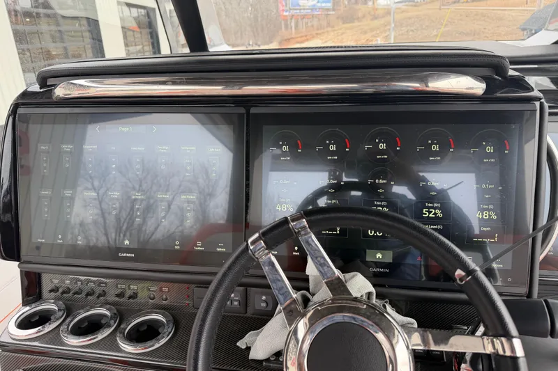 Slide: The Image of 2024 Nor-Tech 500 Sport Center Console dashboard with dual Garmin displays and steering wheel. - 36